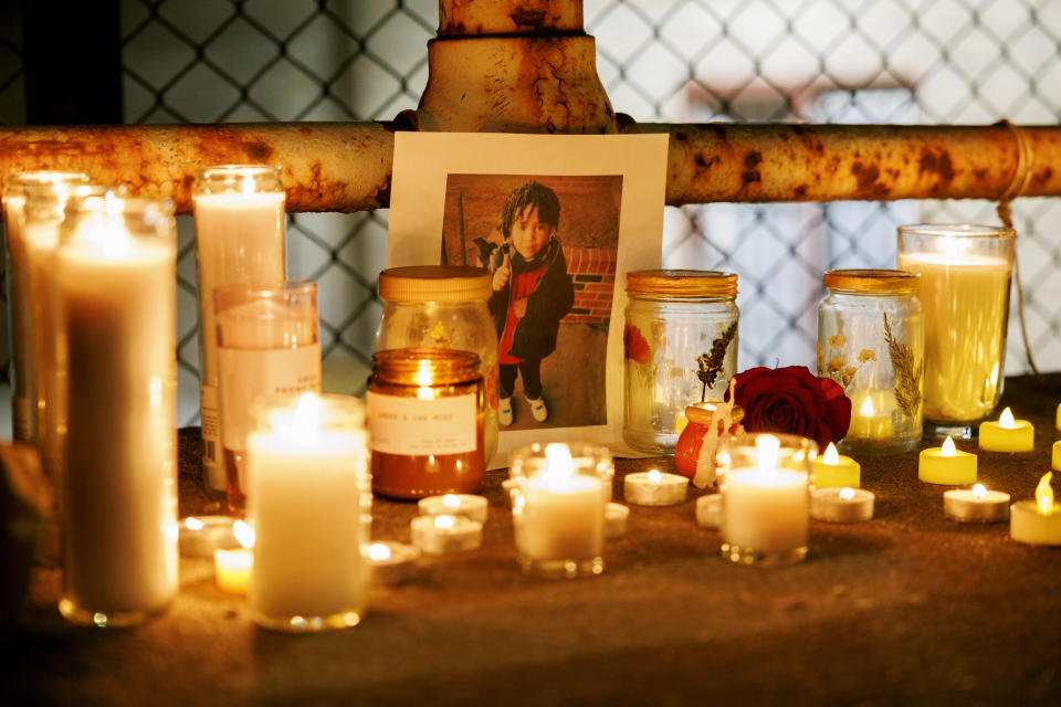 A memorial for Jean Carlos Martinez Rivero sits on the ground next to candles during a vigil for the 5-year-old who died over the weekend at the Lower West Side shelter, Wednesday, Dec. 20, 2023, in Chicago. Thousands of migrants have come to Chicago over the past 16 months, and over 2,000 migrants are housed at the shelter. (Armando L. Sanchez/Chicago Tribune via AP)