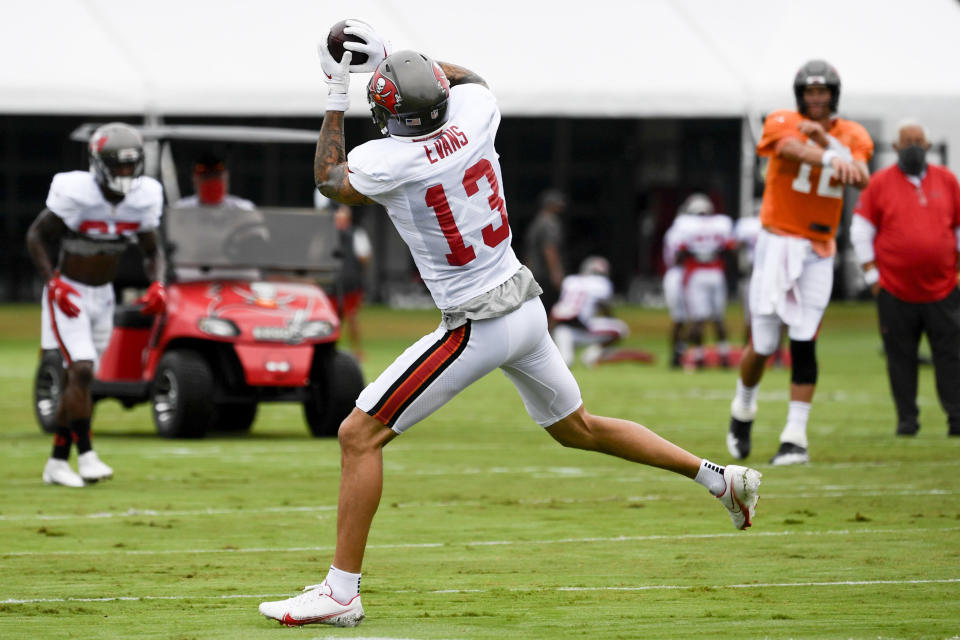 Tom Brady #12 of the Tampa Bay Buccaneers throws a pass to Mike Evans #13 