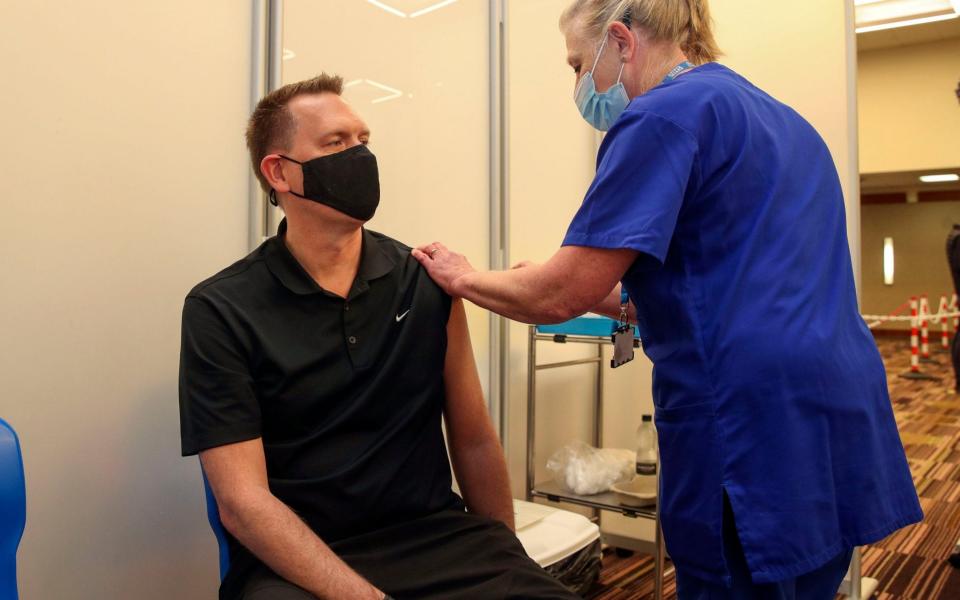 Martin Pluves from Wokingham receives an injection of the Moderna Covid-19 vaccine administered by nurse Paula Bartlett - Steve Parsons/PA Wire