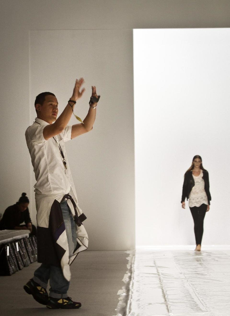 Fashion designer Richard Chai gestures during a rehearsal for his Spring Summer 2014 collection on Thursday, Sept. 5, 2013 in New York. (AP Photo/Bebeto Matthews)