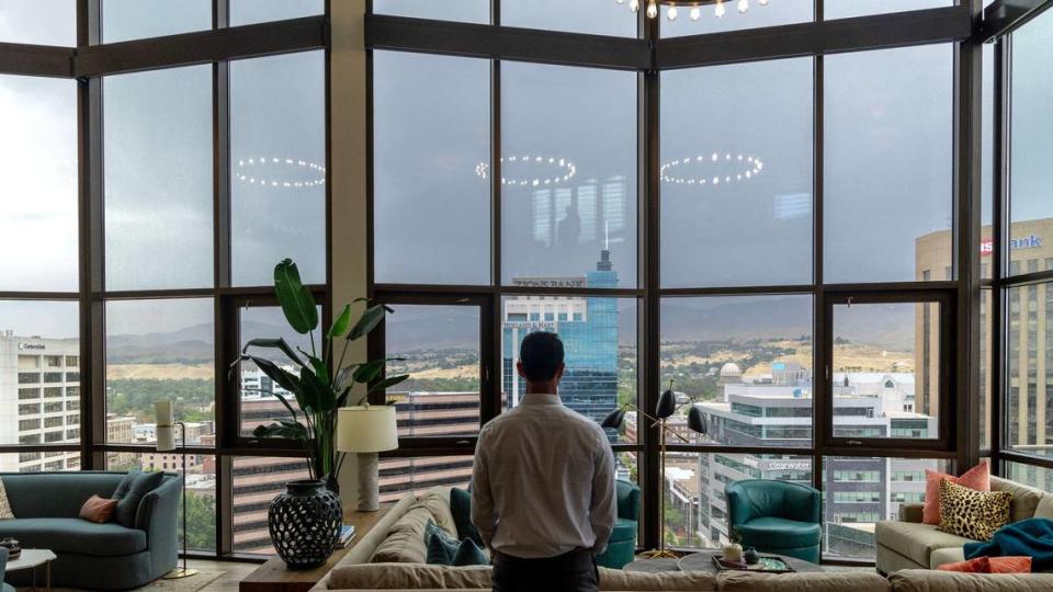 Brett Hughes looks out over downtown Boise from the a penthouse suite atop Aspen Lofts.