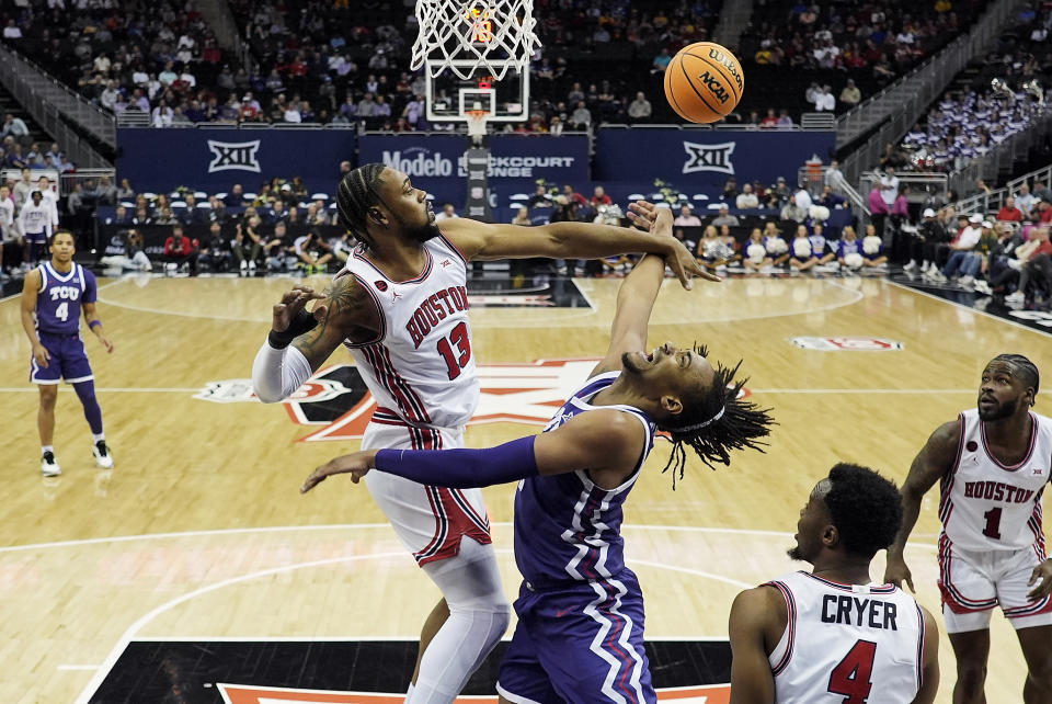 Houston forward J'Wan Roberts (13) blocks a shot by TCU forward Chuck O'Bannon Jr. (5) during the first half of an NCAA college basketball game in the quarterfinal round of the Big 12 Conference tournament, Thursday, March 14, 2024, in Kansas City, Mo. (AP Photo/Charlie Riedel)