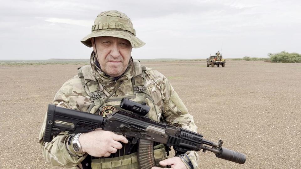 Yevgeny Prigozhin, chief of Russian private mercenary group Wagner, gives an address in camouflage and with a weapon in his hands in a desert area at an unknown location, in this still image taken from video possibly shot in Africa and published August 21, 2023.
