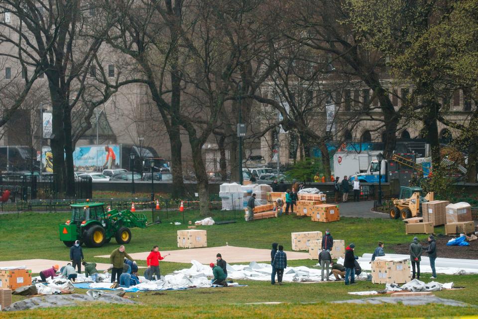 Workers set up a field hospital inside Central Park in front of Mount Sinai Hospital on March 29, 2020.