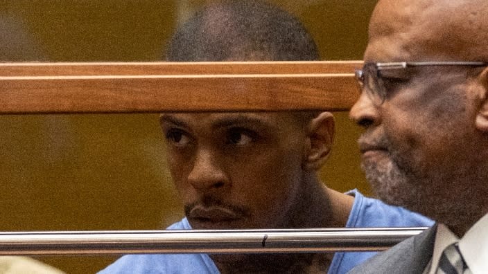 This April 2019 photo shows Eric Ronald Holder Jr. (left), then 29, at his arraignment with his former attorney, Christopher Darden (right), in Los Angeles. (Photo: Patrick Fallon-Pool/Getty Images)