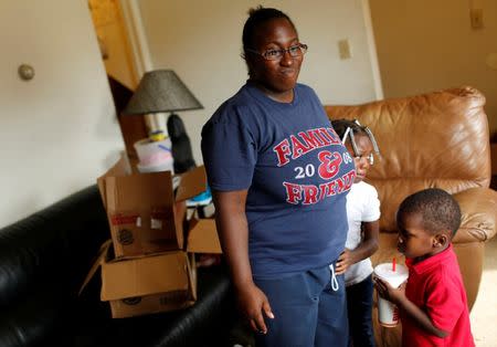 Nayesa Walker speaks to a reporter in her home with her children Kaelynn Lott and Ka'Juan Lott (R) in East Chicago, Indiana, U.S. September 16, 2016. REUTERS/Michelle Kanaar