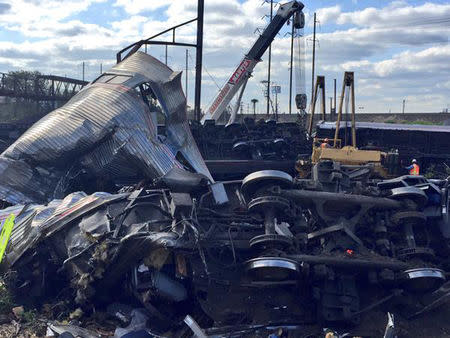 Emergency personnel and members of the Philadelphia Fire Department investigate the scene of a train accident in Philadelphia, Pennsylvania, in this handout photo provided by the Philadelphia Fire Department, May 13, 2015. REUTERS/Philadelphia Fire Department/Handout