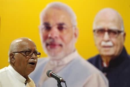 Lal Krishna Advani addresses his supporters during an election campaign in front of his portrait along with the portrait of Narendra Modi (C), in Ahmedabad April 20, 2014. REUTERS/Amit Dave/Files