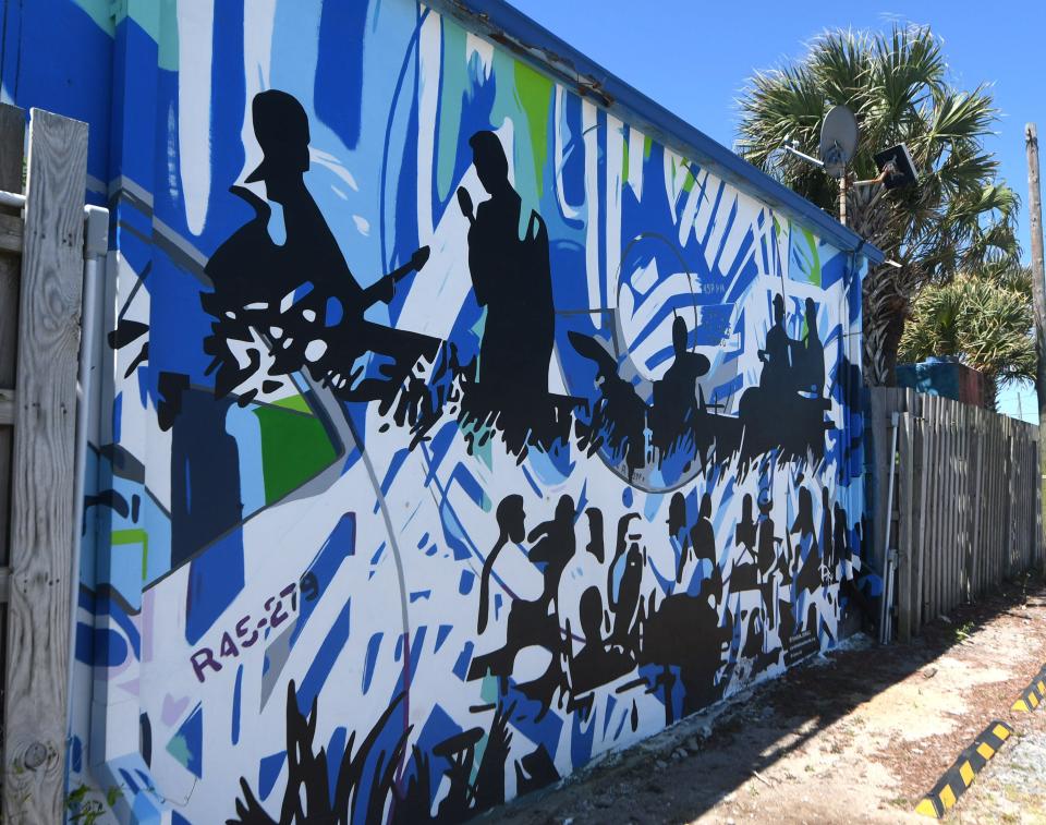 The "Record Weekend" mural on the side of Sea Witch at 227 Carolina Beach Ave. is one of the numerous murals throughout Carolina Beach.     [MATT BORN/STARNEWS]