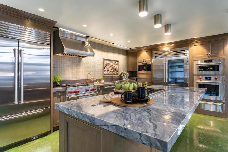 A demo kitchen in the new Bordona’s showroom designed by Wendy Glaister, featuring a punchy, acid green floor