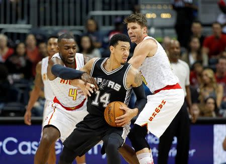 Dec 12, 2015; Atlanta, GA, USA; San Antonio Spurs guard Danny Green (14) gets by the defense of Atlanta Hawks forward Paul Millsap (4) and guard Kyle Korver (26) in the first quarter of their game at Philips Arena. Mandatory Credit: Jason Getz-USA TODAY Sports