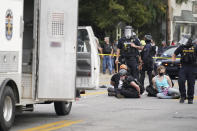 Louisville police detain a a group who marched, Wednesday, Sept. 23, 2020, in Louisville, Ky. A grand jury has indicted one officer on criminal charges six months after Breonna Taylor was fatally shot by police in Kentucky. The jury presented its decision against fired officer Brett Hankison Wednesday to a judge in Louisville, where the shooting took place. (AP Photo/John Minchillo)