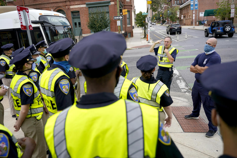 FILE - In this Sept. 9, 2020 photo, Baltimore Police Academy cadets listen to an instructor during an on the field class session learning to direct traffic, Wednesday, Sept. 9, 2020, in Baltimore. As rising murder rates gain attention in U.S. cities, Republicans have ramped up misleading attacks by casting Democrats as anti-police. It's a message they believe helped them stave off greater Democratic gains and one with renewed potency particularly in cities that cut police department budgets amid calls to overhaul policing last year. It's not clear whether the GOP strategy, with roots back to President Nixon's law-and-order message, will be a success for a party that has little support in American cities. But Republicans hope to stem their decline in suburbs with by attacking Democrats' on domestic safety. (AP Photo/Julio Cortez)