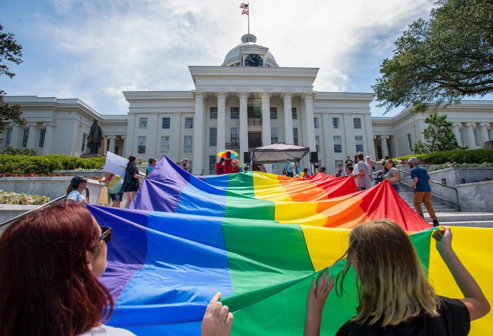 Marchers carry a giant rainbow flag up the steps of the Alabama Capital Building during the Montgomery Pride March and Rally in downtown Montgomery, Ala., on Saturday June 29 , 2019. 