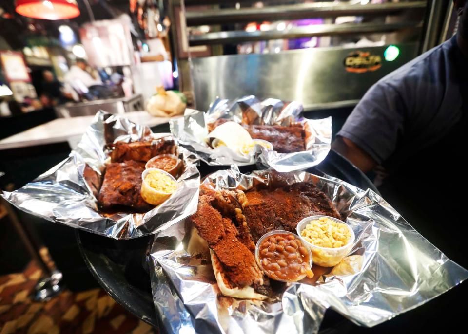 Darrin Howse holds a tray of ribs inside The Rendezvous in Downtown Memphis on Sept. 26, 2023. The charbroiled ribs at The Rendezvous are world-famous. The restaurant is celebrating its 75th anniversary this year.