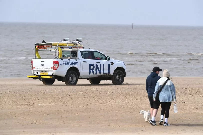 RNLI Lifeguard on patrol on Crosby beach