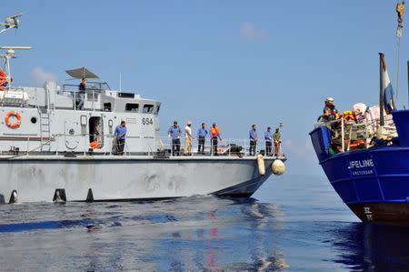 A Libyan coast guard vessel is seen next to the Mission Lifeline rescue boat in the central Mediterranean Sea, June 21, 2018. Hermine Poschmann/ Misson-Lifeline/Handout via REUTERS