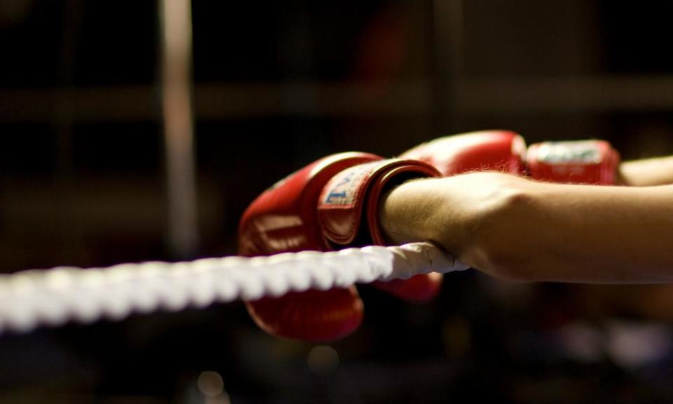 Close-up of boxer leaning on ropes