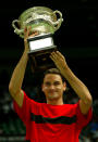 <p>Roger Federer of Switzerland holds up the Australian Open Trophy after victory against Marat Safin of Russia </p>