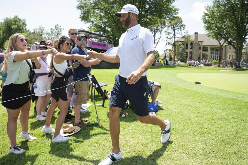 Captain Dustin Johnson, right, of 4Aces GC, greets golf fans during the second round of LIV Golf Tulsa at the Cedar Ridge Country Club, Saturday, May. 13, 2023, in Broken Arrow, Okla. (Photo by Amy Kontras/LIV Golf via AP)