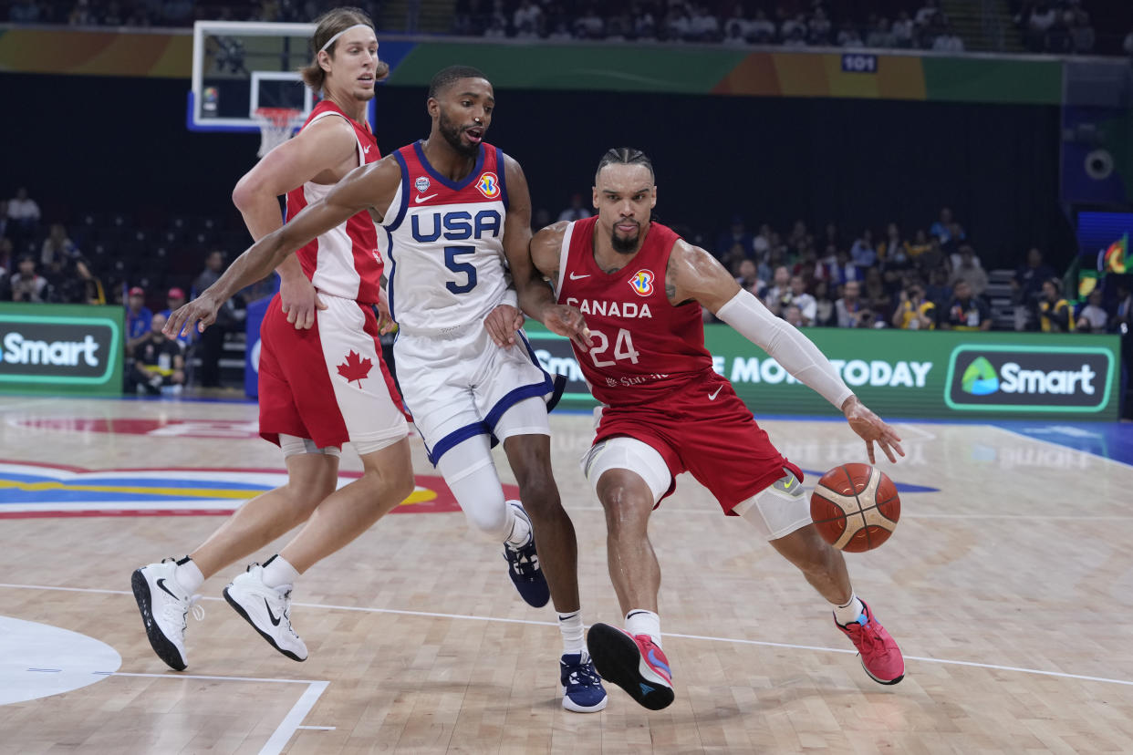 Canada forward Dillon Brooks dribbles past U.S. forward Mikal Bridges during the FIBA Basketball World Cup bronze-medal game in Manila, Philippines, on Sept. 10, 2023. (AP Photo/Michael Conroy)