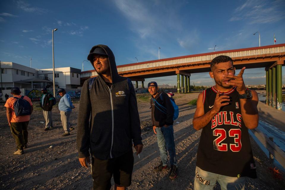 Venezuelan migrants watch as other migratns cross the Rio Grande into the U.S. These Venezuelan migrants had been expelled to Ciudad Juarez from the U.S. on Oct. 14, 2022.