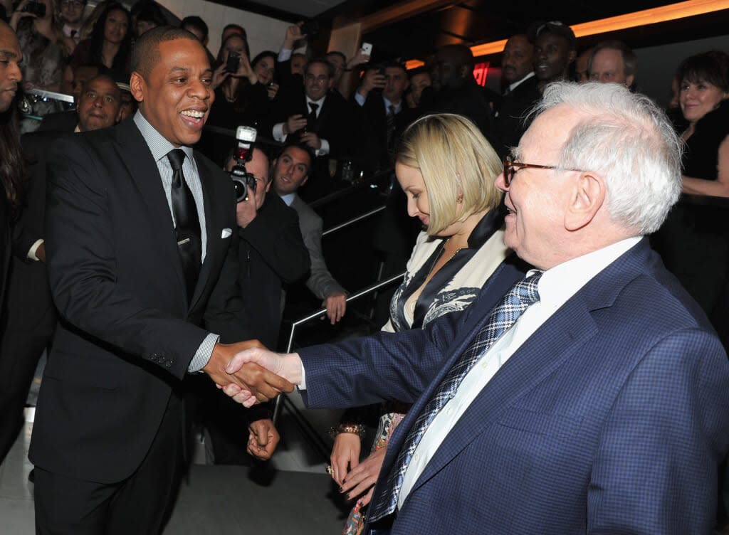 Jay-Z and Warren Buffett greet each other at the grand re-opening in January 2012 of Jay-Z’s 40/40 Club in New York City. The Department of Justice has found that a Pennsylvania-based mortgage company owned by a division of Buffett’s Berkshire Hathaway discriminated against potential Black homeowners in three states. (Photo by Theo Wargo/Getty Images for Berk Communications)