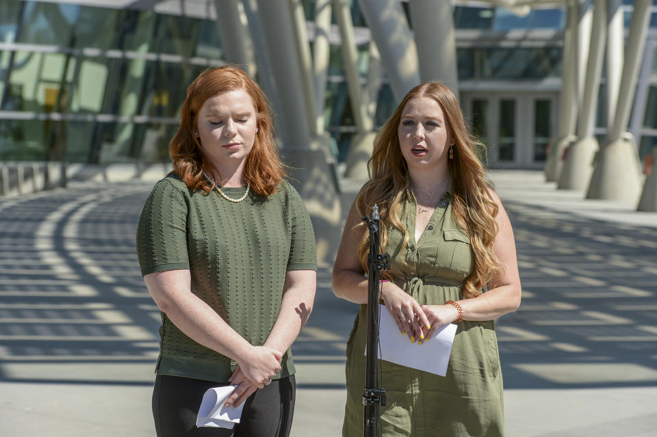 In this Sunday, June 23, 2019 photo, Ashley Fine and Kennedy Stoner, close friends of missing person Mackenzie Lueck, speak during a press conference outside the Salt Lake City Police Department in Salt Lake City. Police and friends are investigating the disappearance of the 23-year-old University of Utah student, whose last communication with her family said she arrived at Salt Lake City International Airport on Monday, June 17. (Leah Hogsten/The Salt Lake Tribune via AP)