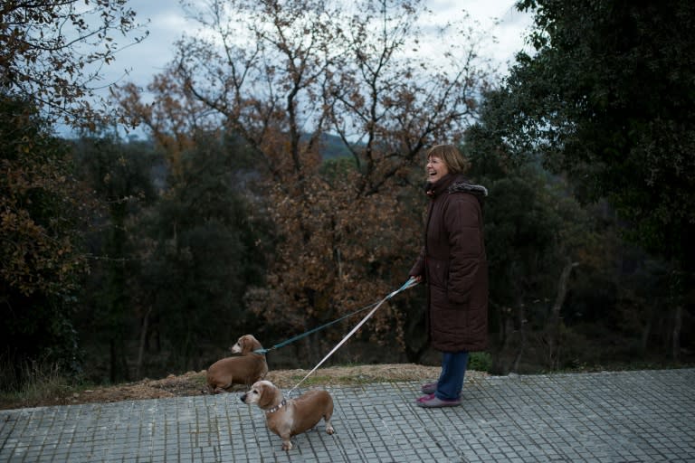 Presentacion Espinola walks her two sausage dogs in the bellwether village Fogars de la Selva