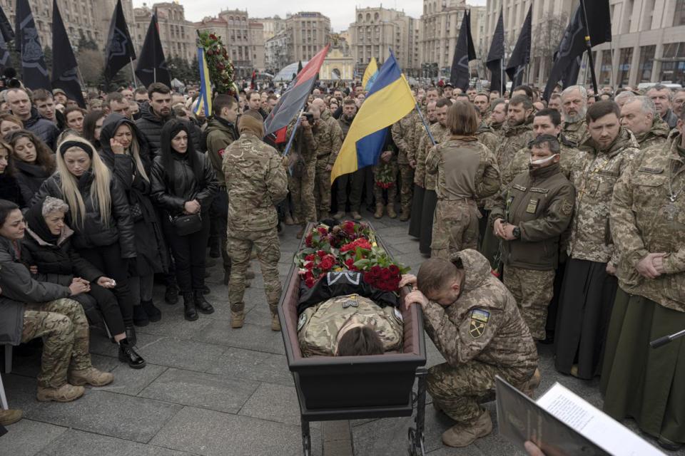 Valerii Zaluzhnyi, commander-in-chief of the Armed Forces of Ukraine (bottom right), pays his respects at the funeral of fallen Ukrainian military commander Dmytro Kotsiubailo, also known as "Da Vinci" at the Independence Square in Kyiv on March 10, 2023. (Andrew Kravchenko/Bloomberg via Getty Images)