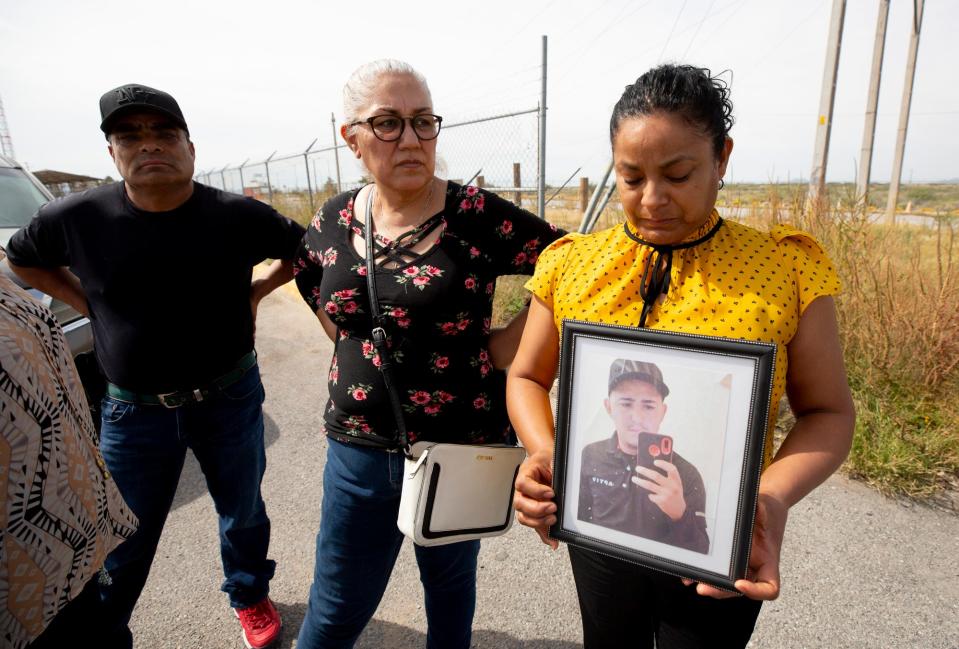 A family member of Jesús Sepúlveda clutches a photo of the 22-year-old migrant who was killed on Sept. 27 in Hudspeth County. Authorities returned the man's remains to family members in Juárez.