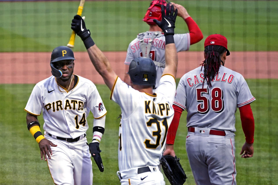 Pittsburgh Pirates' Rodolfo Castro (14) scores on a single by Diego Castillo off Cincinnati Reds starting pitcher Luis Castillo (58) during the second inning of a baseball game in Pittsburgh, Saturday, May 14, 2022. (AP Photo/Gene J. Puskar)