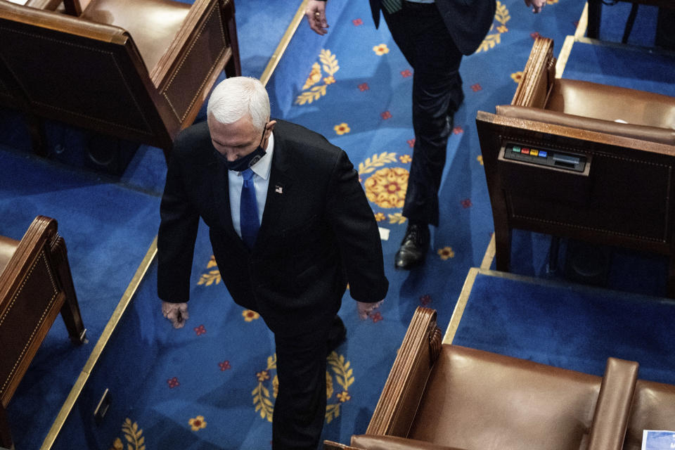 Vice President Mike Pence walks off the House floor as a joint session of the House and Senate convenes to confirm the Electoral College votes cast in November's election, at the Capitol in Washington, Wednesday, Jan. 6, 2021. (Erin Schaff/The New York Times via AP, Pool)