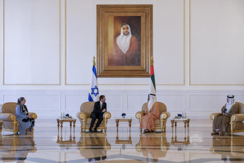 In this photo provided by the Israeli Government Press Office, Israeli President Isaac Herzog, center left, and First Lady Michal Herzog meet with UAE Foreign Minister, Sheikh Abdullah bin Zayed Al Nahyan, center right, in Abu Dhabi, United Arab Emirates, Sunday, Jan. 30, 2022. Israel's president arrived in the United Arab Emirates on Sunday in the first official visit by the country's head of state, the latest sign of deepening ties between the two nations as tensions rise in the region. (Amos Ben Gershom/GPO via AP)