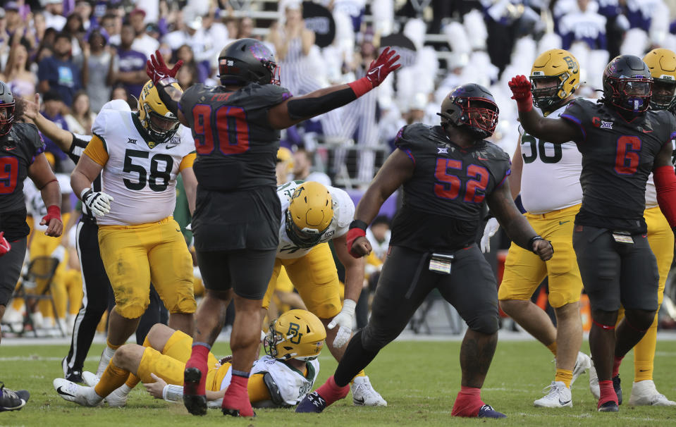 TCU defensive lineman Damonic Williams (52) reacts after sacking Baylor quarterback Blake Shapen, bottom left, in the first half of an NCAA college football game, Saturday, Nov. 18, 2023, in Fort Worth, Texas. (Rod Aydelotte/Waco Tribune-Herald via AP)