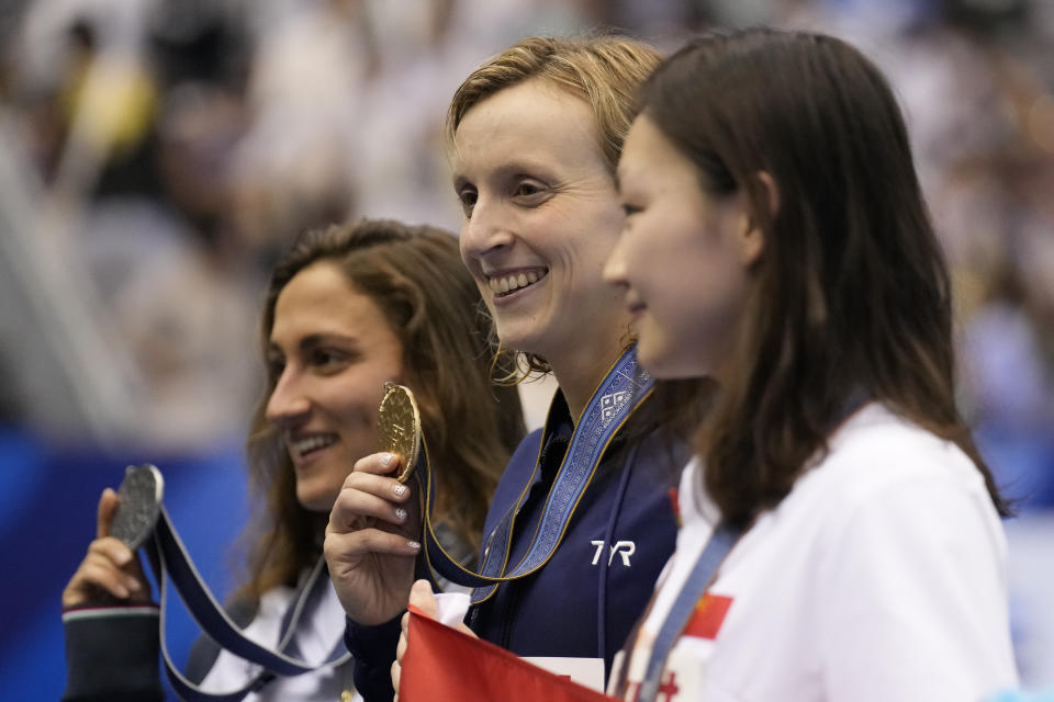 Gold medalist Katie Ledecky of United States, center, silver medalist Simona Quadarella, left, of Italy and bronze medalist Li Bingjie of China pose during ceremonies at women's 1500m freestyle finals at the World Swimming Championships in Fukuoka, Japan, Tuesday, July 25, 2023. (AP Photo/Lee Jin-man)