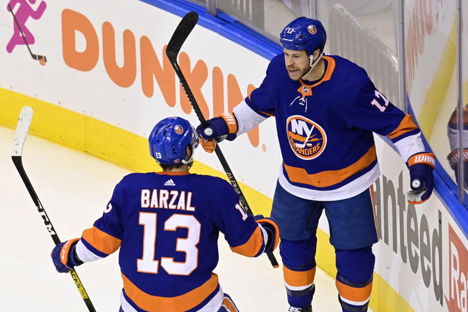 New York Islanders left wing Matt Martin (17) celebrates with center Mathew Barzal (13) after scoring against Philadelphia Flyers goaltender Carter Hart during second-period NHL Stanley Cup Eastern Conference playoff hockey game action in Toronto, Saturday, Aug. 29, 2020. (Frank Gunn/The Canadian Press via AP)