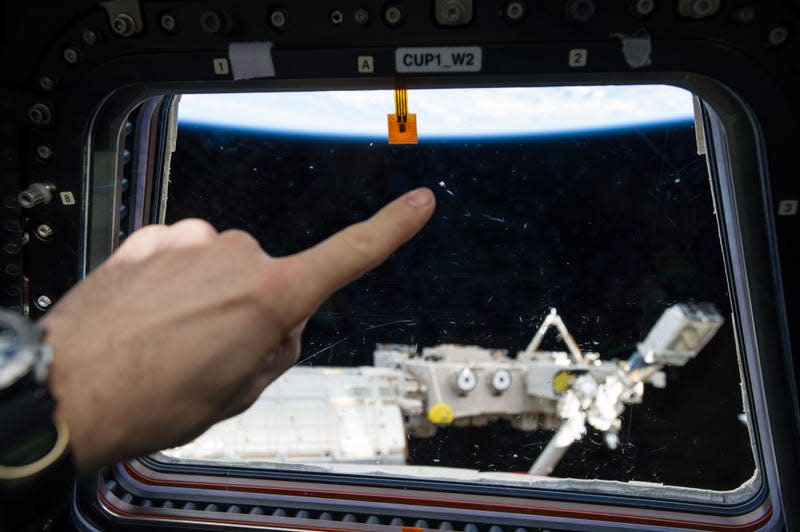 This 2016 photo shows a mark left on an ISS window from an apparent micrometeor strike.