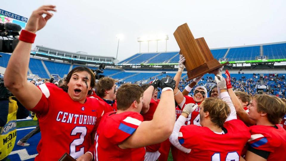 Christian Academy-Louisville quarterback Cole Hodge (2), left, celebrates with his teammates after beating Bell County for the Class 3A state championship at Kroger Field in Lexington on Saturday. Hodge was named MVP of the game.