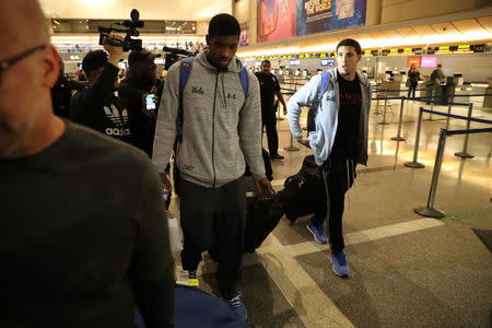 UCLA basketball players LiAngelo Ball (R) and Cody Riley arrive at LAX after flying back from China where they were detained on suspicion of shoplifting, in Los Angeles, California U.S. November 14, 2017. REUTERS/Lucy Nicholson