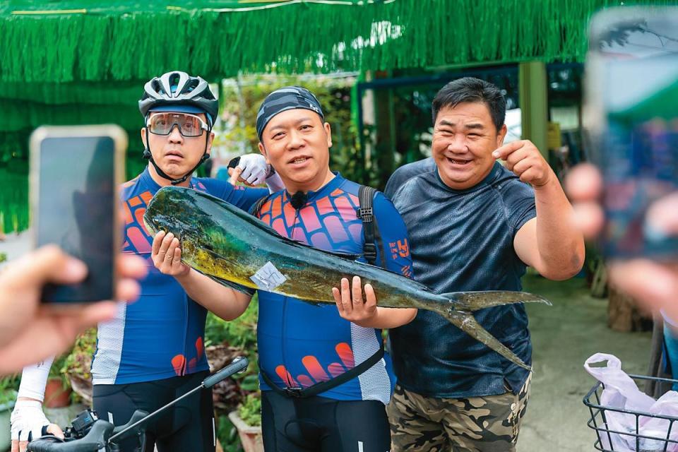 哈林（左）與卜學亮（中）驚見剛捕獲的鬼頭刀魚，與在地居民合照留念。（好看娛樂提供）