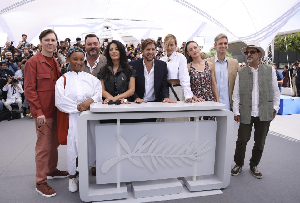 Jury president Ruben Ostlund, centre, poses with jury members Paul Dano, from left, Rungano Nyoni, Denis Menochet, Maryam Touzani, Julia Ducournau, Brie Larson, Damian Szifron and Atiq Rahimi at the photo call for the jury at the 76th international film festival, Cannes, southern France, Tuesday, May 16, 2023. (Photo by Vianney Le Caer/Invision/AP)