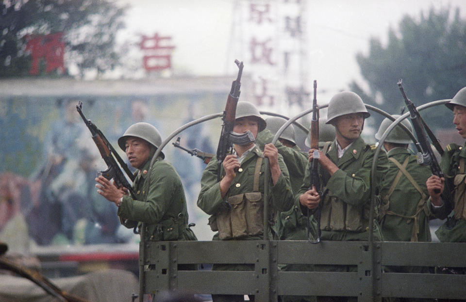 FILE - In this June 7, 1989, file photo, Chinese troops keep a sharp eye out as their truck makes a momentary stop on Changan Blvd in Beijing, China. (AP Photo/Terril Jones, File)
