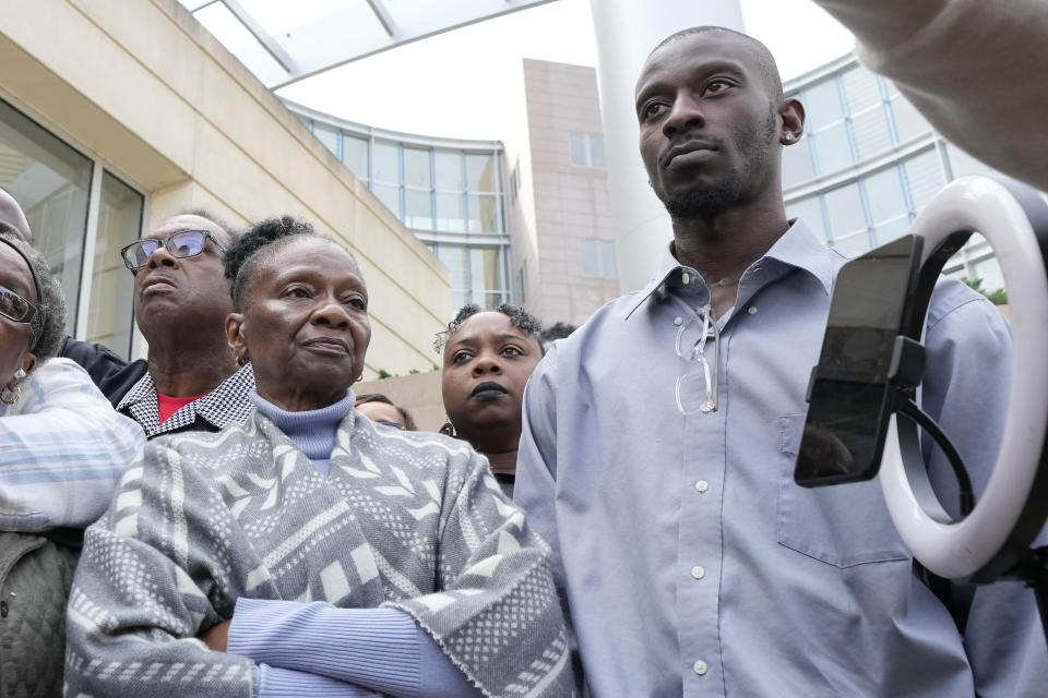 Mary Jenkins and her son Michael Corey Jenkins, right, listen as civil co-counsel Malik Shabazz, left, speaks with reporters outside the federal courthouse in Jackson, Miss., Thursday, March 21, 2024, following the sentencing of former Rankin County deputy Brett McAlpin to more than 27 years in federal prison for his role in the racially motivated, violent torture of Michael Corey Parker and his friend Eddie Terrell Jenkins last year. McAlpin is the fifth of six former Mississippi Rankin County law enforcement officers to be sentenced in federal court since Tuesday. (AP Photo/Rogelio V. Solis)