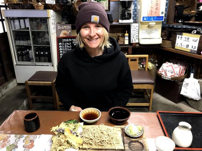 Woman sitting at a table about to eat