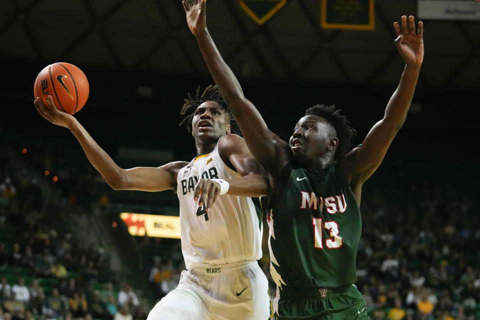 Baylor guard Ja'Kobe Walter, left, goes up for a shot against Mississippi Valley State guard Darrius Clark during the second half of an NCAA college basketball game, Friday, Dec. 22, 2023, in Waco, Texas. Baylor won 107-48. (AP Photo/Julio Cortez)