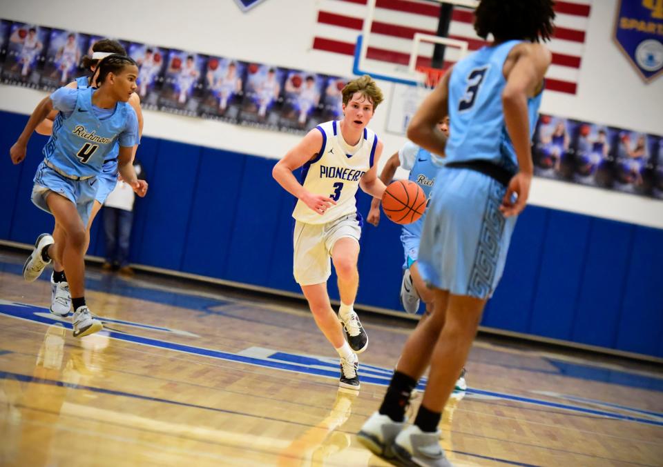 Croswell-Lexington's Zach Kroetsch dribbles down the court during a game last season. He scored 21 points in the Pioneers' 60-56 loss to Port Huron Northern on Saturday.