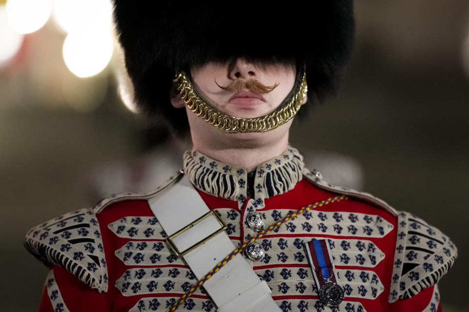 A member of the military marches on The Mall, in central London, early Wednesday, May 3, 2023, during a rehearsal for the Coronation of King Charles III which will take place at Westminster Abbey on May 6. (AP Photo/Andreea Alexandru)