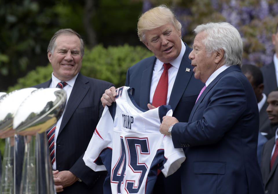 FILE - In this April 19, 2017 file photo, President Donald Trump is presented with a New England Patriots jersey from Patriots owner Robert Kraft, right, and head coach Bill Belichick during a ceremony on the South Lawn of the White House in Washington, where the Patriots were honored for their Super Bowl LI victory. In addition to the jersey, the team confirmed on Tuesday, Aug. 22, 2017, that Kraft decided after the team's visit to also have a Super Bowl championship ring made for Trump. (AP Photo/Susan Walsh, File)