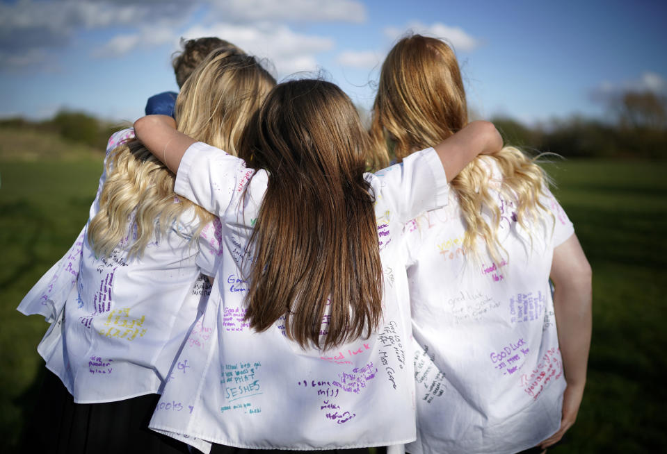 NORTHWICH, UNITED KINGDOM - MARCH 20: Senior schoolchildren embrace and mark their 'leavers' day early as they head home and schools are closed due to the ongoing coronavirus pandemic on March 20, 2020 in Northwich, England . Coronavirus (COVID-19) has spread to at least 182 countries, claiming over 10,000 lives and infecting more than 250,000 people. There have now been 3,269 diagnosed cases in the UK and 144 deaths. (Photo by Christopher Furlong/Getty Images)